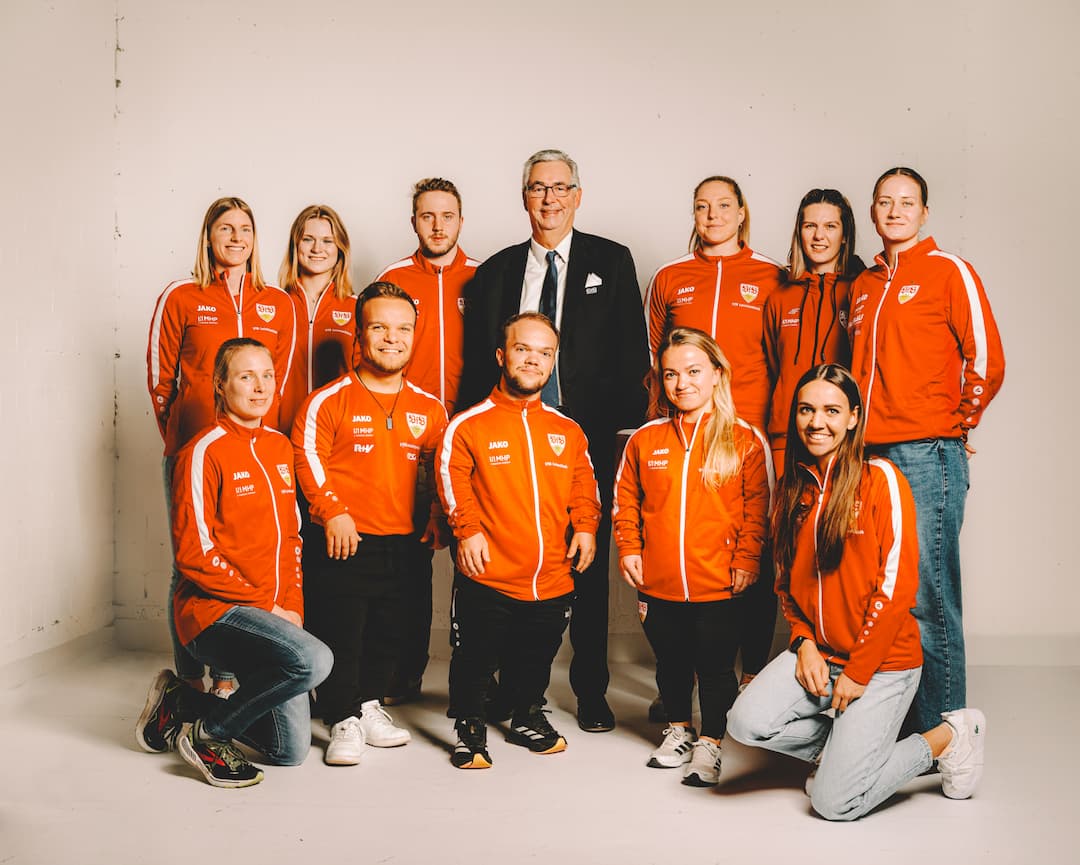 Team members in red jackets